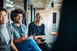 Smiling business people that are learning a language in a meeting room at work.