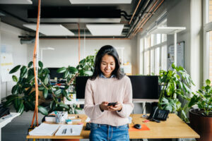 happy employee using a smartphone for professional development