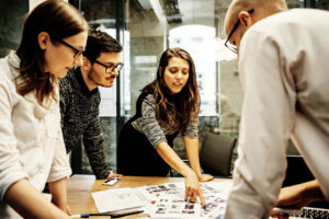 A team of young business people in a modern office is discussing work projects.