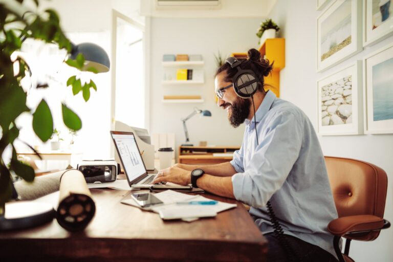 man smiling at laptop