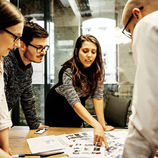 A team of young business people in a modern office is discussing work projects.