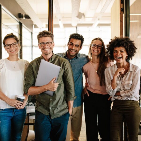 Young business people are smiling and talking in an office.